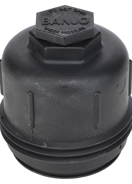 Close-up of a black, cylindrical plastic cap with ridges on the sides, engraved with "B.A.NJO" and the warning "DO NOT OPEN UNDER PRESSURE" on the top. The cap is identified as AGCO | Cap - Ag053088 from the brand AGCO.