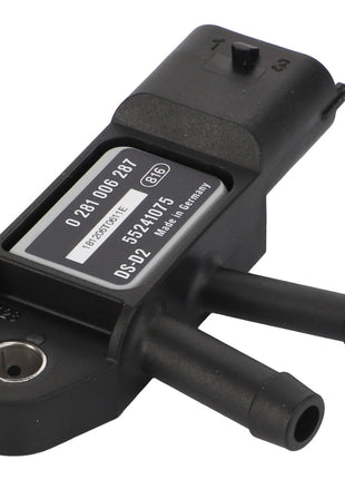 Close-up of a sleek black AGCO | Sensor - Acp0311400 device with multiple nozzles, featuring a label that displays numbers and barcodes in fine detail.