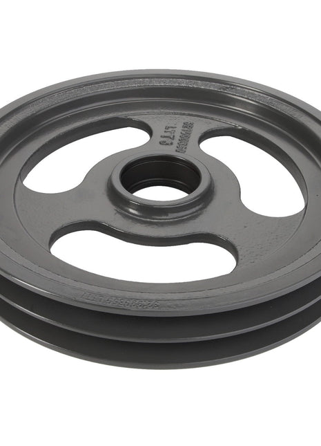 The AGCO Tensioner - La321990850 is a grey metal pulley with three spokes and a central hole. It features a groove around its perimeter designed for optimal belt traction.