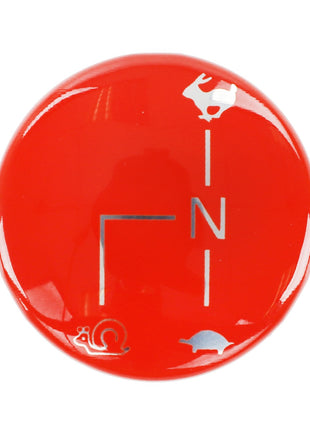 The AGCO Badge (Acp0668860) features a red circular dial with three symbols that represent different speed levels: a rabbit at the top, a turtle at the bottom right, and a snail at the bottom left. Note: There is currently no detailed product description available.