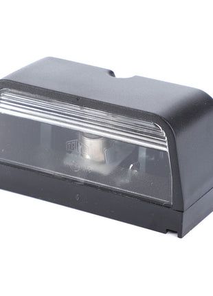 The AGCO | Light, License Plate - V30328500 is a black rectangular plastic device with a transparent front panel and an identifiable metallic component inside, perfect for ensuring visibility of your tractor number plate.