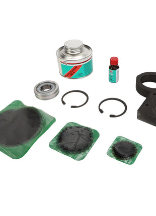 Product Description: The AGCO BEARING CARRIER - D28251562, featuring various machinery parts and maintenance items including a can of cleaner, a small bottle of liquid, two circular rings, two sealed components, a housing part, and a bearing, is displayed on a white background.