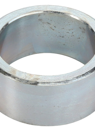 A detailed close-up image of the AGCO | SPACER - D28800328, a sleek and metallic cylindrical ring featuring an open center and a smooth finish.