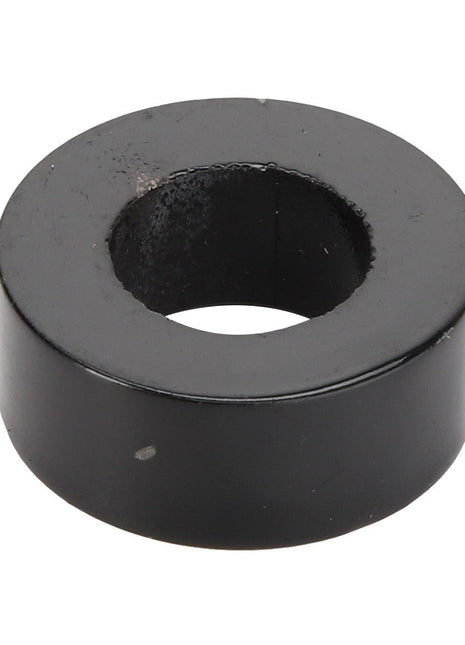 The AGCO | BUSH - AG120283 by AGCO is a black, cylindrical metal washer with a central hole used typically as a spacer or to provide a bearing surface in mechanical applications.