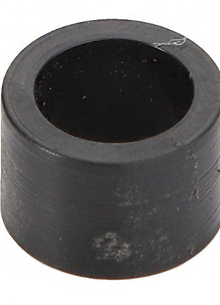 A close-up of the AGCO Spacer - Acw1756700, a cylindrical black rubber bushing with a hollow center. No current product description information is available for this item.