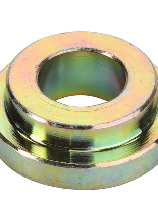 Close-up of the AGCO | SPACER - D28880354, a circular, metallic washer featuring a central hole and a slightly raised outer edge. The surface exhibits a reflective, yellow-greenish tint and appears polished and clean. Further product description information is currently unavailable.