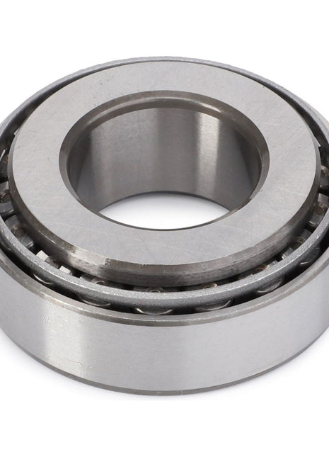 A close-up of the AGCO | Taper Roller Bearing - 9-1002-0033-3, featuring an inner and outer ring with a cylindrical shape and internal rolling elements, ideal for managing thrust loads.