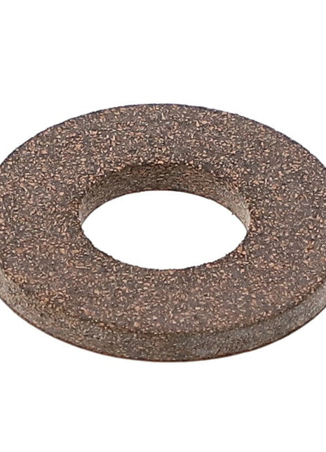 A close-up image of the AGCO | WASHER - K7873, featuring its circular shape with a central hole and a coarse, textured surface. Product description information is not currently available.