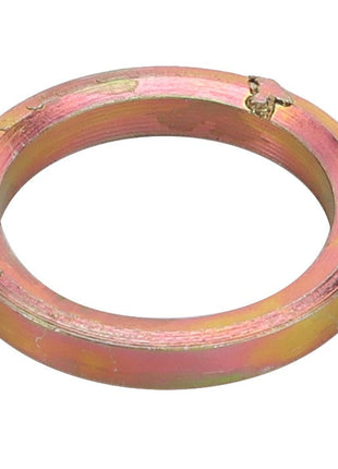 A circular, metallic gasket under the product name AGCO | SPACER - D26735317 has a scratched surface and a small crack at the top edge. No current product description information available.