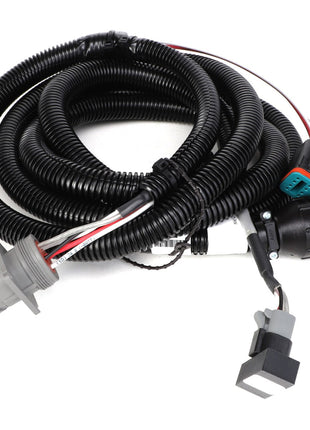 The AGCO | HARNESS - AG136332 by AGCO is a meticulously coiled black wiring harness that features various connectors and includes some exposed red, white, and black wires.