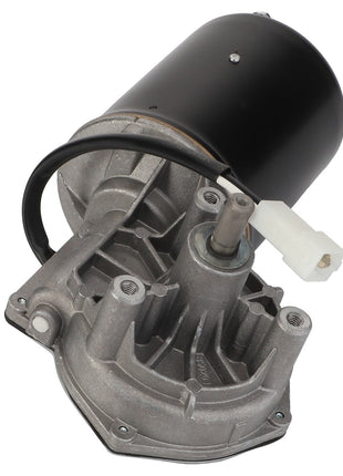 Close-up of the AGCO | Electric Motor - Acx2407450 assembly with wires and a white connector, showcasing its metallic housing and a black cylindrical component on top.