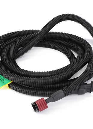 The AGCO | Harness - Act0023720, featuring a coiled black corrugated wire conduit with red and black connectors on each end, enhances machinery reliability with AGCO Parts Genuine Electrics.