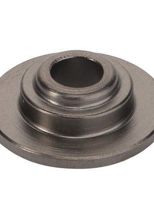 The AGCO | Washer - Acp0676180, offered by AGCO, features a raised central cylinder and several intricately carved concentric grooves.