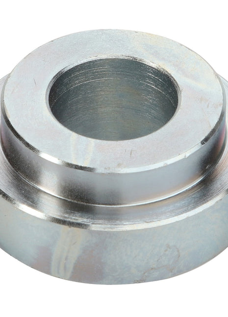 AGCO | SPACER - D28480457 by AGCO is a metal spacer with a central hole, engineered for precise insertion into various structures to maintain distance or provide robust support.