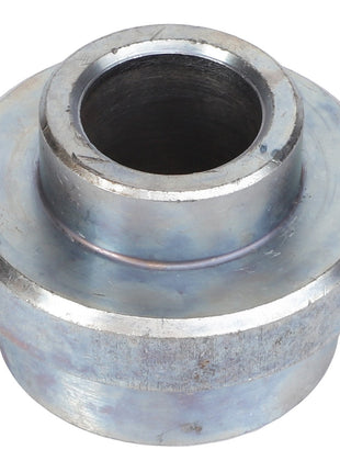 The AGCO Bush - Acw9076190 is a metallic cylindrical bushing featuring a wide flange near the top and a hollow central section. Further product description information is currently unavailable.