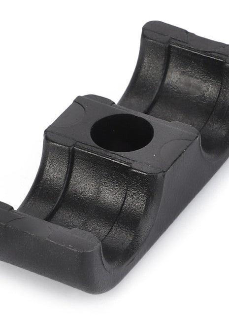 The AGCO | CLAMP - AL735215 is a meticulously designed black plastic clamp featuring a central circular hole and curved ends, perfect for securing cylindrical objects with precision.