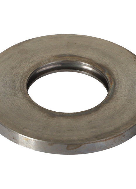The AGCO | COVER - E65283 is a metallic washer featuring a large central hole, designed for use in machinery or equipment assembly. There is no additional product description information available at this time.