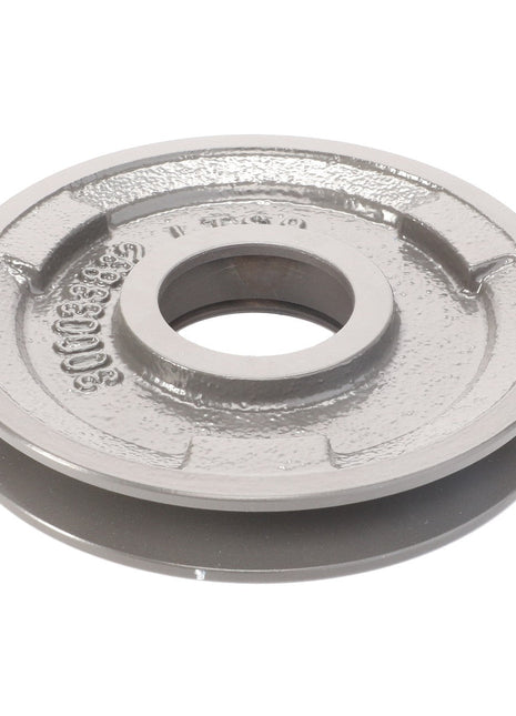 An AGCO Belt Tensioner - La300033832, a round, gray, metal industrial pulley with a central hole and detailed with indents and raised markings on its surface, isolated on a white background.