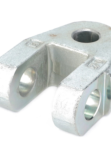 The AGCO Clevis - Acp0346780 by AGCO is a silver metal yoke with two parallel arms, each featuring a circular hole. The top includes a larger circular hole, and the surface shows some wear along with subtle machining marks.