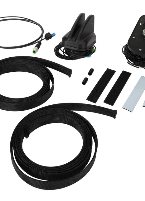 Components of the AGCO | Telemetry Kit - Acp0679170, including cables, a roof mount base, adhesive strips, and protective sleeves, meticulously arranged on a white background.