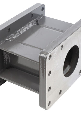 The AGCO Spacer - La320719950, a gray-painted metal component, is rectangular in shape with a large circular opening and multiple bolt holes on its flanges.