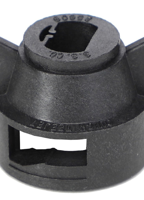 The AGCO Cap - Ag055180 from AGCO is a black plastic automotive part, with a cylindrical shape, featuring a circular top with a slot and two protruding side tabs. No current product description available.