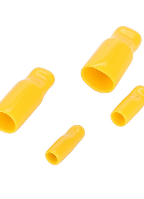 Four yellow plastic electrical wire connectors of varying sizes are arranged on a white background, reminiscent of the precision and quality you'd expect from AGCO's Kit - 4226449M91.