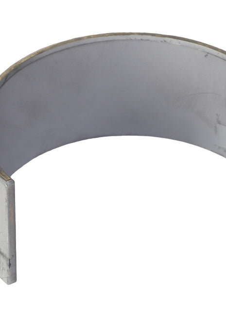 This detailed product description showcases the AGCO Conrod Bearing - V836179785, a curved metal bearing shell with a partially cylindrical shape and an open side, now available for purchase.