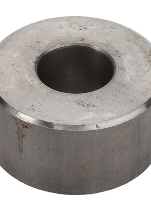 Close-up of the AGCO BUSH - D28485327 with a central hole, slightly cylindrical in shape, and a distressed surface finish. Note: No current product description information is available.