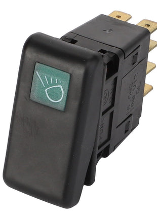 The AGCO Light Switch - Acw1669890 displays a black rocker design featuring a headlight symbol on its green indicator. The switch is equipped with several brass terminals on the back to ensure efficient electrical connections.