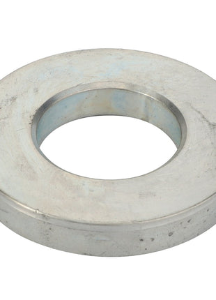 The AGCO | WASHER - D28150131 is a silver metallic washer with a central circular hole, utilized in various mechanical and structural applications. No current product description information is available.