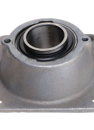 The AGCO Bearing Housing - Acw2873530 is a meticulously engineered metal housing featuring a circular opening and four bolt holes, designed to support rotating shafts.