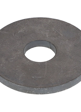 Close-up of the AGCO WASHER - E59514, a large, flat, metallic washer with a central hole, often utilized in mechanical applications.