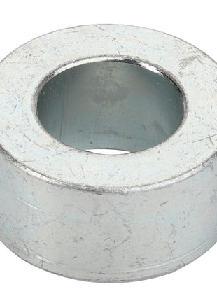 A close-up of the AGCO Spacer - Acp0520460, a cylindrical metal washer with a central hole.