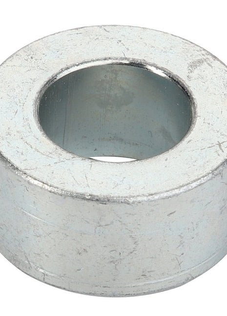 A close-up of the AGCO Spacer - Acp0520460, a cylindrical metal washer with a central hole.