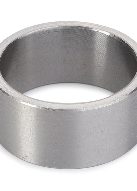 A close-up of the AGCO Bush - La300129094, a cylindrical metal ring with a smooth surface, showcasing its empty interior and uniform thickness.