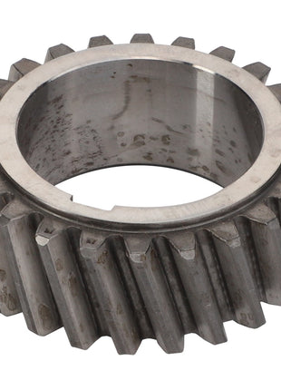 A close-up image of an AGCO | Helical Gear - V836122840 with visible teeth and a central hole. The gear has a worn, slightly tarnished surface, showcasing AGCO's renowned durability in their genuine parts.