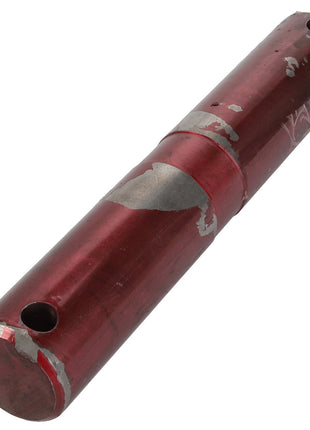 The AGCO | Pin - Acp0018090 is a cylindrical red metal rod featuring a rough surface and two holes drilled through it. No current product description available.