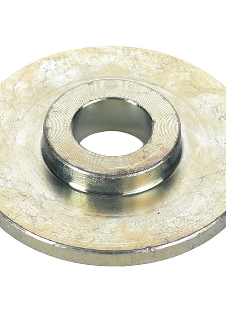 The AGCO Pivot Bushing - Acw3761810 is a circular metallic washer with a central hole and a slightly raised inner ring, showcasing impeccable craftsmanship.