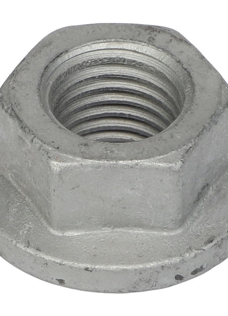 Close-up of the AGCO Hex Flange Nut - Acw1023960, showcasing its internal threading. The hexagonal nut, branded AGCO, is made of metal with a slightly worn surface. No current product description information is available.