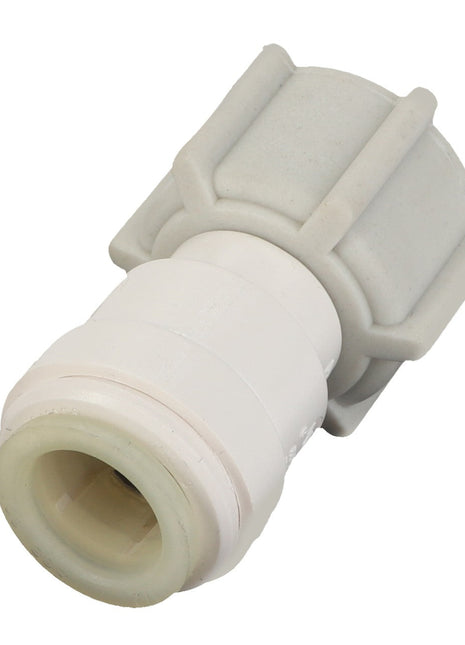 Close-up of an AGCO | Connection - Acm4100196 white plastic pipe connector with a hexagonal base and a cylindrical body, showcasing its efficient design for optimal function.