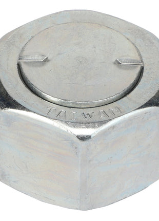 A close-up of an AGCO CAP - AG519381 hexagonal metal cap nut gleaming under bright light, with the word "TAIWAN" meticulously engraved on its flat top surface.