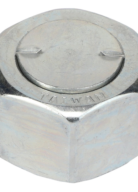 A close-up of an AGCO CAP - AG519381 hexagonal metal cap nut gleaming under bright light, with the word "TAIWAN" meticulously engraved on its flat top surface.