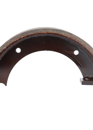 The durability of Genuine AGCO Parts designed for heavy-duty braking is exemplified by the AGCO | Brake Shoe - D46100663, a worn, semi-circular metal brake shoe equipped with two mounting holes and a brake pad attached to its curved edge.