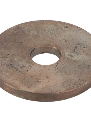The AGCO | Washer - Acw1701240 is a large, flat, round metal washer with a central hole. The surface appears worn and tarnished.