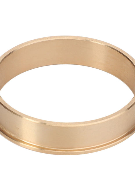 The AGCO Bush - La312939360 by AGCO is a simple gold-colored metal ring featuring a smooth surface, devoid of engravings, and a subtly raised edge. No current product description available.