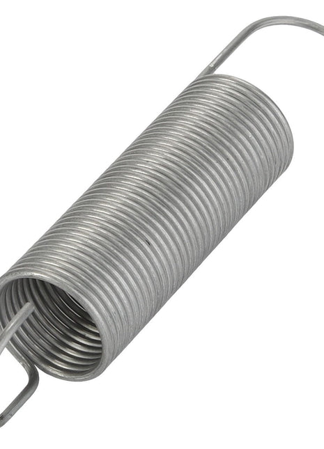 A close-up of the AGCO | SPRING - CG1224505000, a coiled metal extension spring with hooks at both ends. The spring, gleaming in its silver hue, appears to be crafted from durable steel.