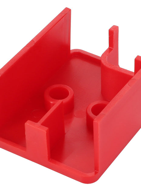 The AGCO Cover - Acp0672640 is a red plastic mount or holder with compartments and slots, perfect for organizing tools or components efficiently.