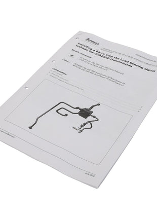 Instructional manual titled "AGCO | Instructions - Act0026980" featuring a diagram of a load-sensing signal tube for a Hino 500 ProShift transmission, complete with detailed illustrations. The document is neatly organized with three hole-punches along the left edge for easy storage in binders.