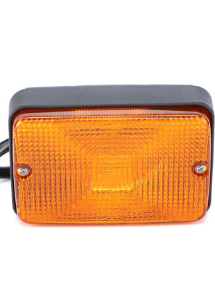 A rectangular amber-colored AGCO Turn Signal - Acw0152020 featuring screw attachments on both sides and a black plastic housing ensures reliability and safety for your vehicle.